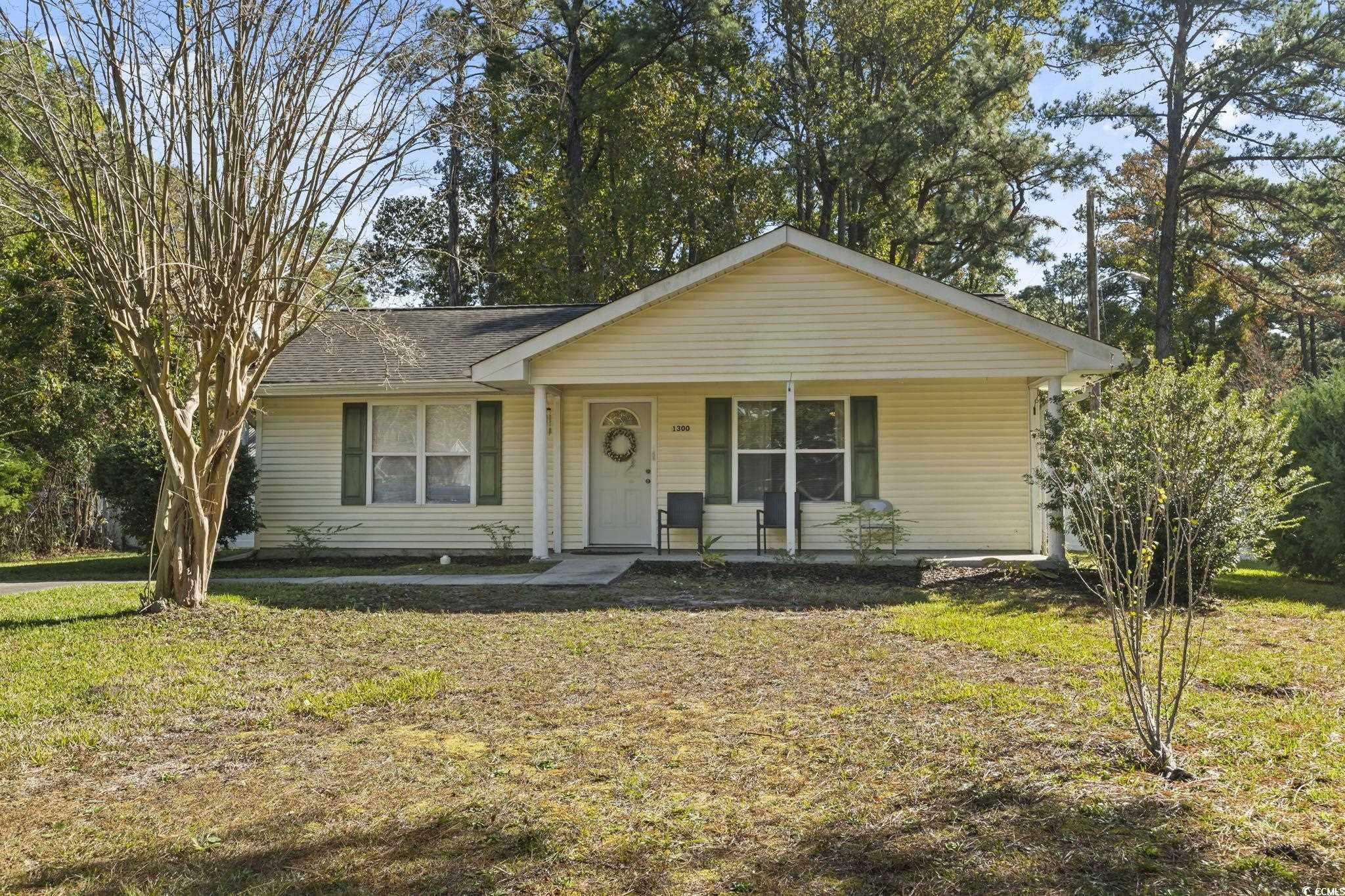 View of front of house with a porch and a front la