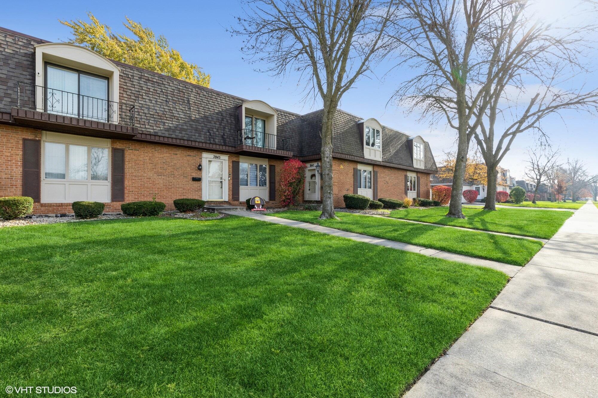 a brick building with a yard in front of it