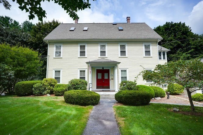 a front view of a house with garden