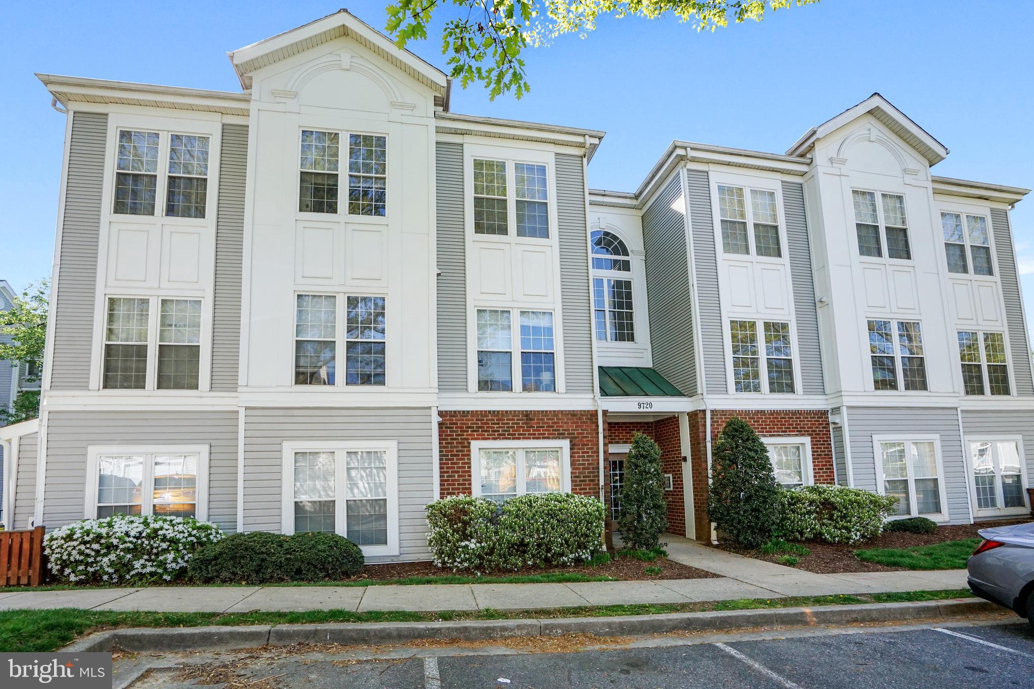 a front view of a residential apartment building with a yard