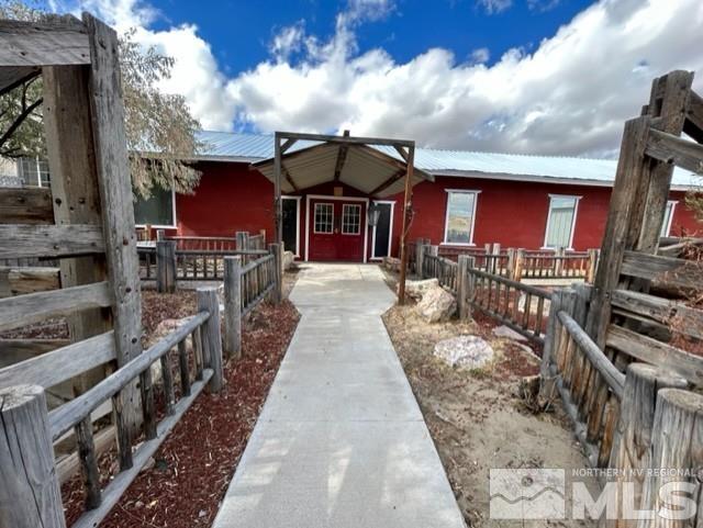 a view of a house with wooden fence