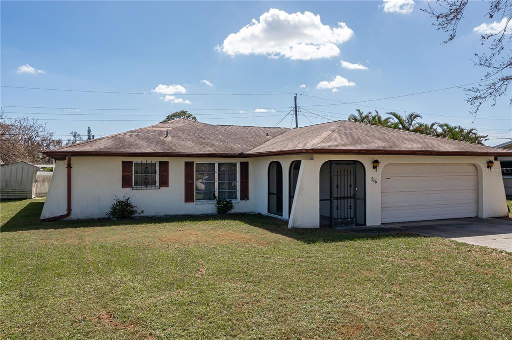 a view of a house with a yard and garage