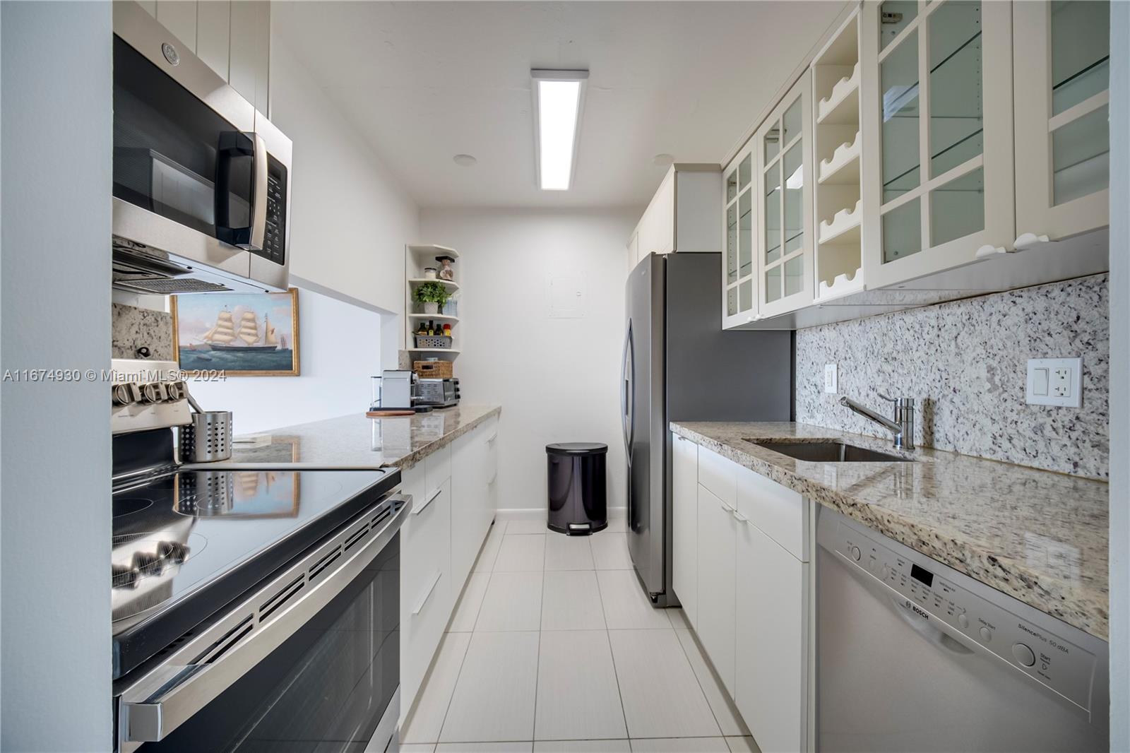 a kitchen with stainless steel appliances granite countertop a sink and cabinets