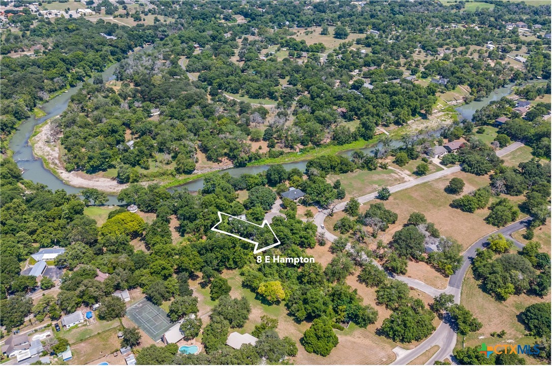 an aerial view of a houses with a yard