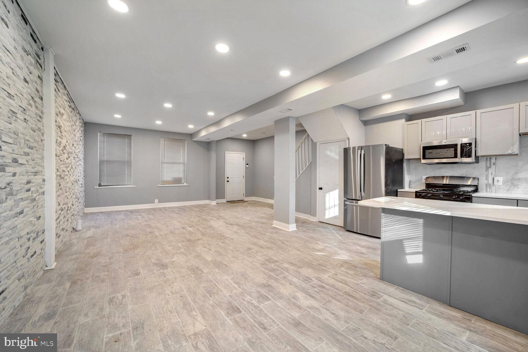 a view of kitchen with stainless steel appliances cabinets