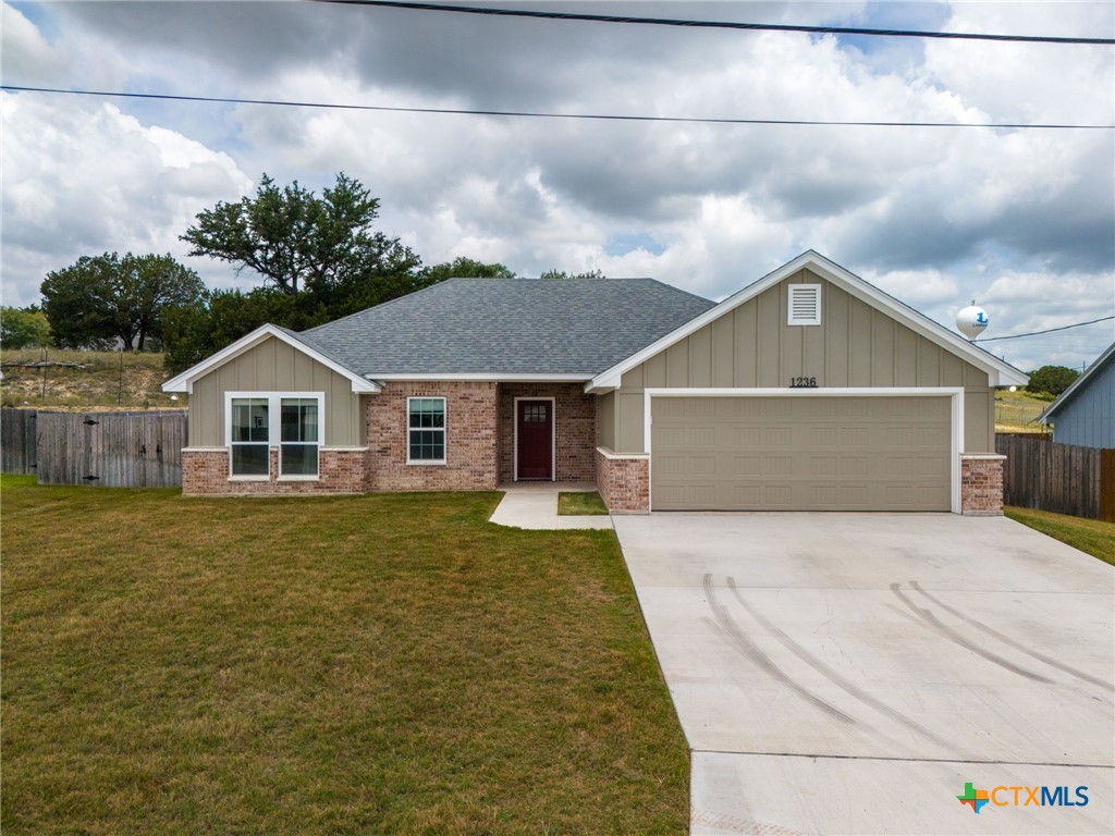 a front view of house with yard and green space