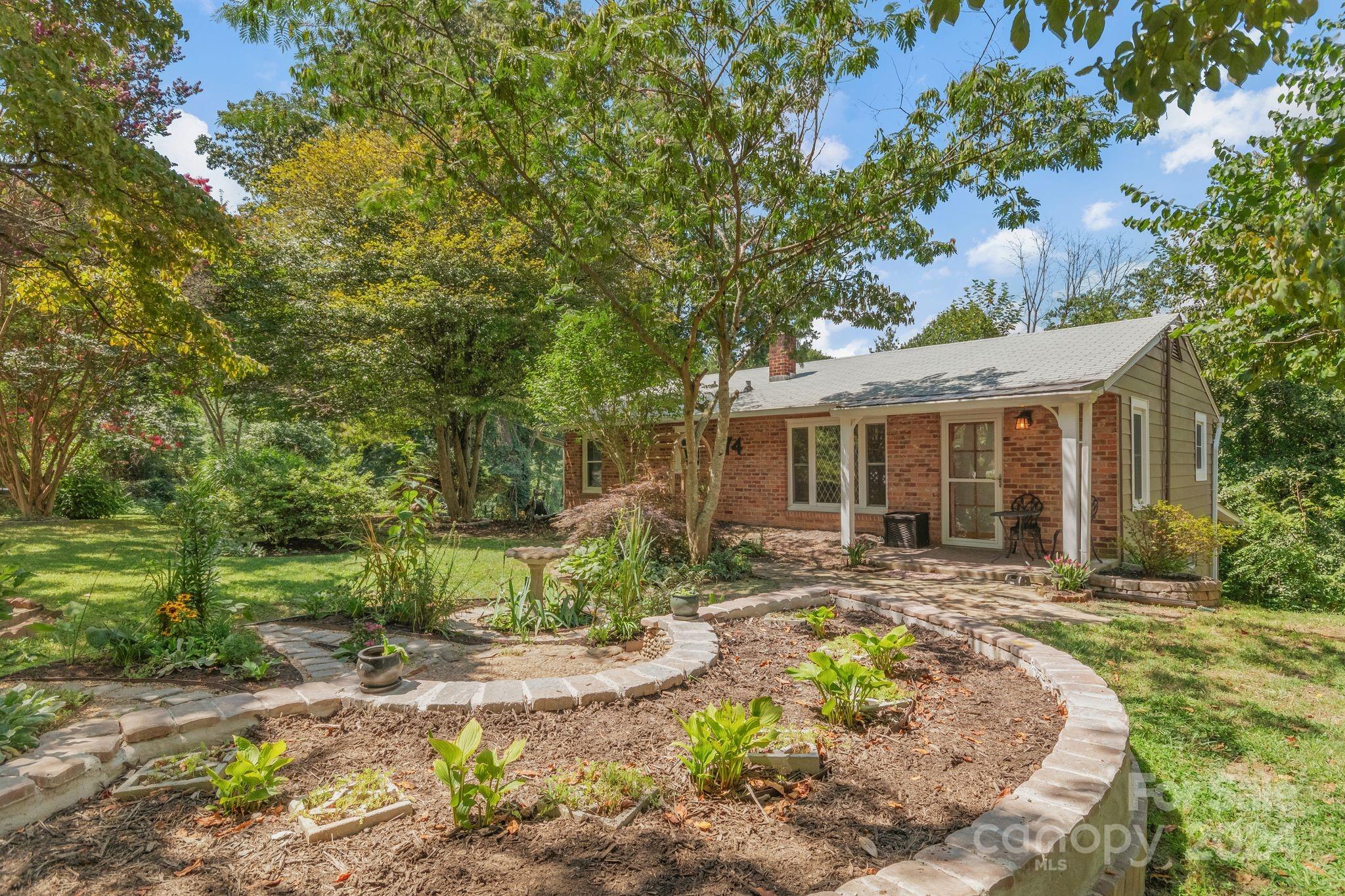 a front view of house with a garden and patio