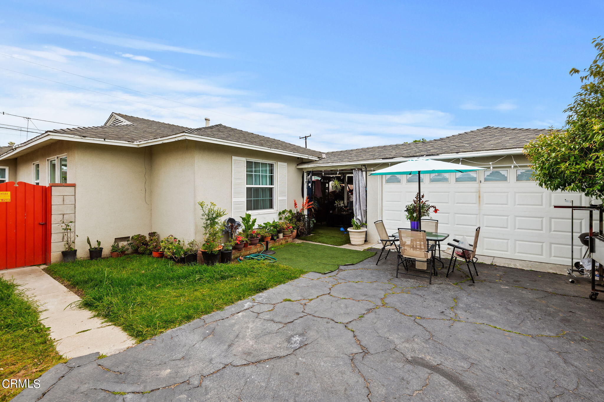 a view of a house with backyard and a patio