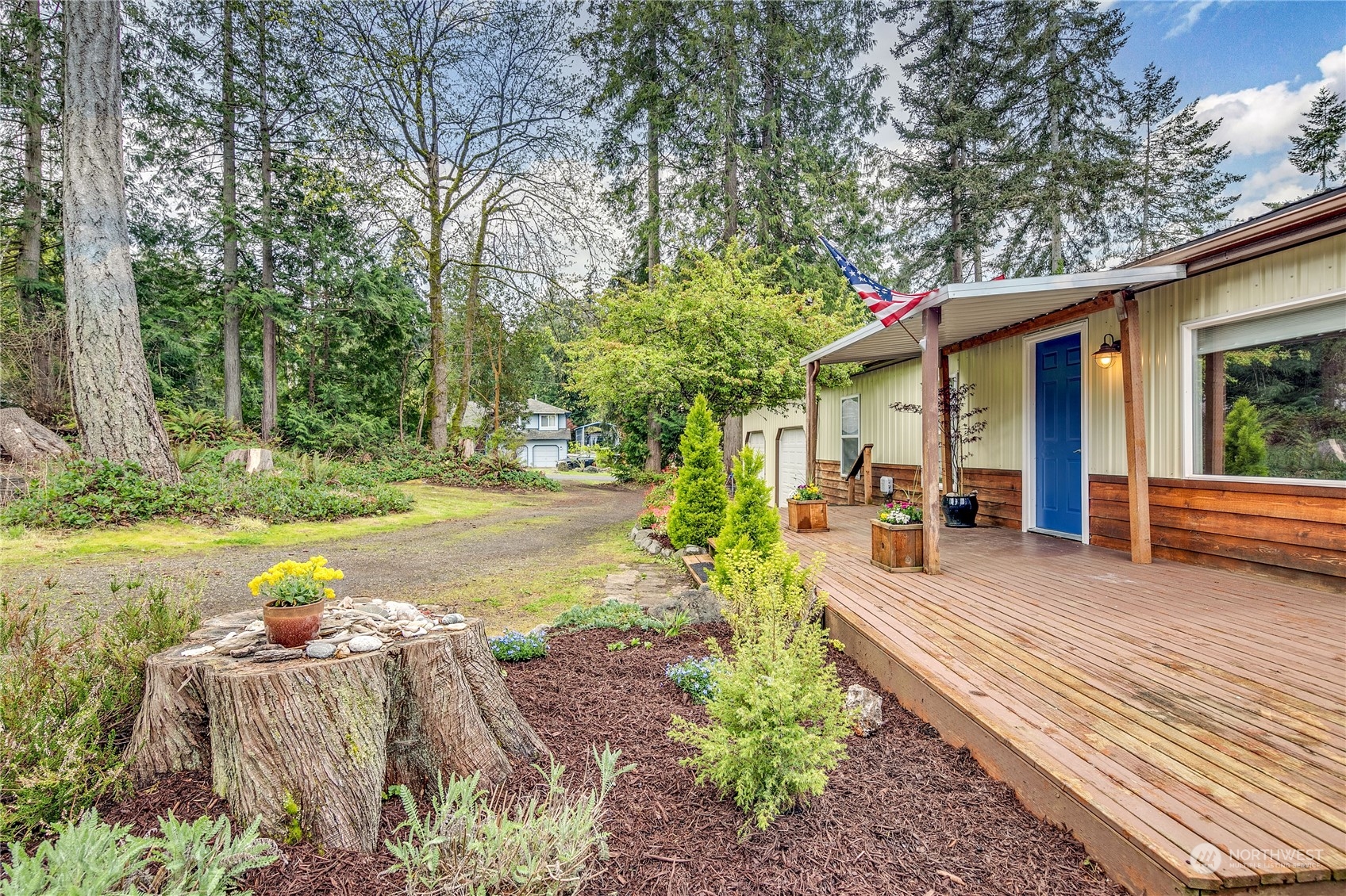 a view of a house with backyard and sitting area