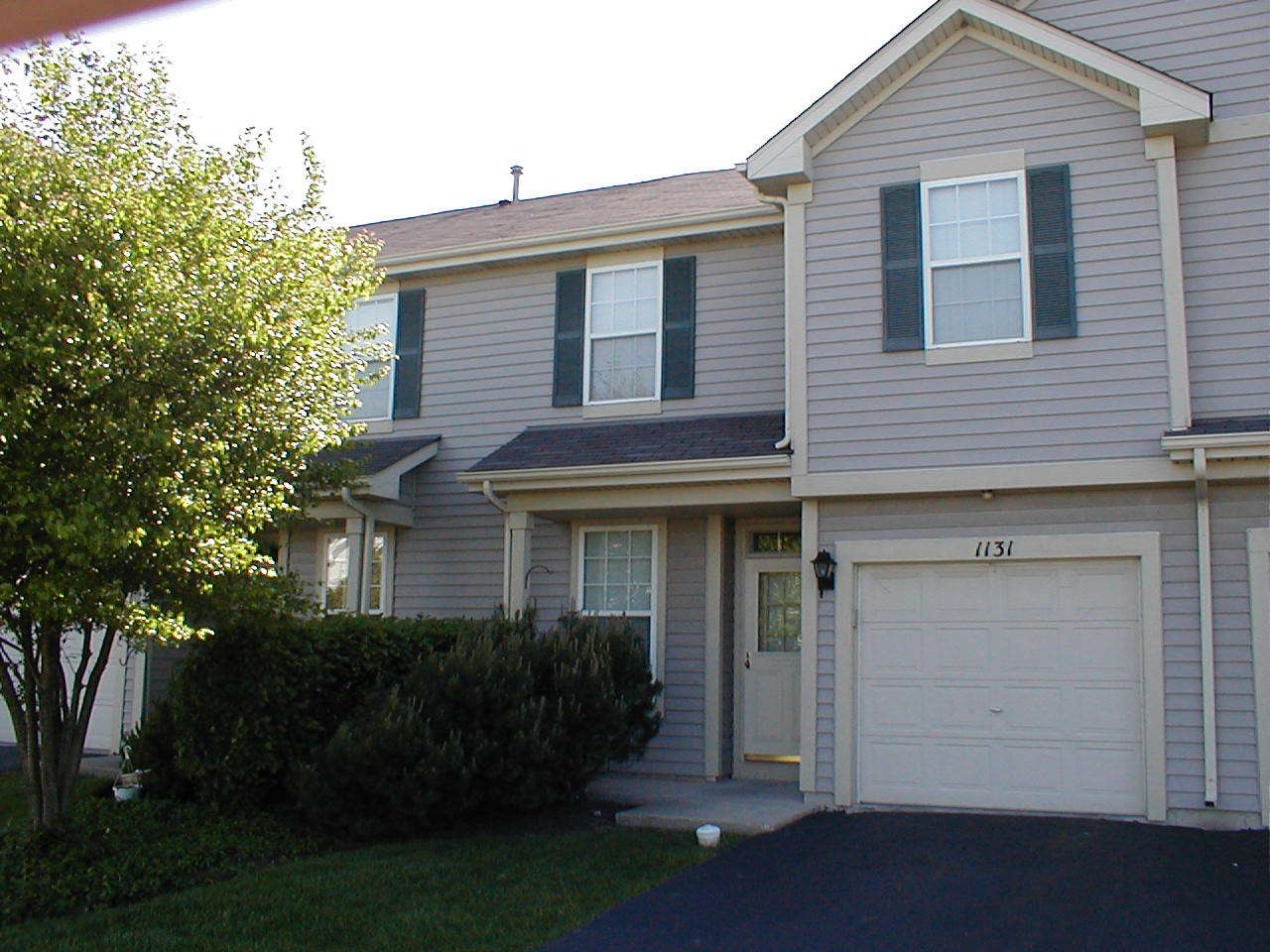 a view of house with outdoor space and garden