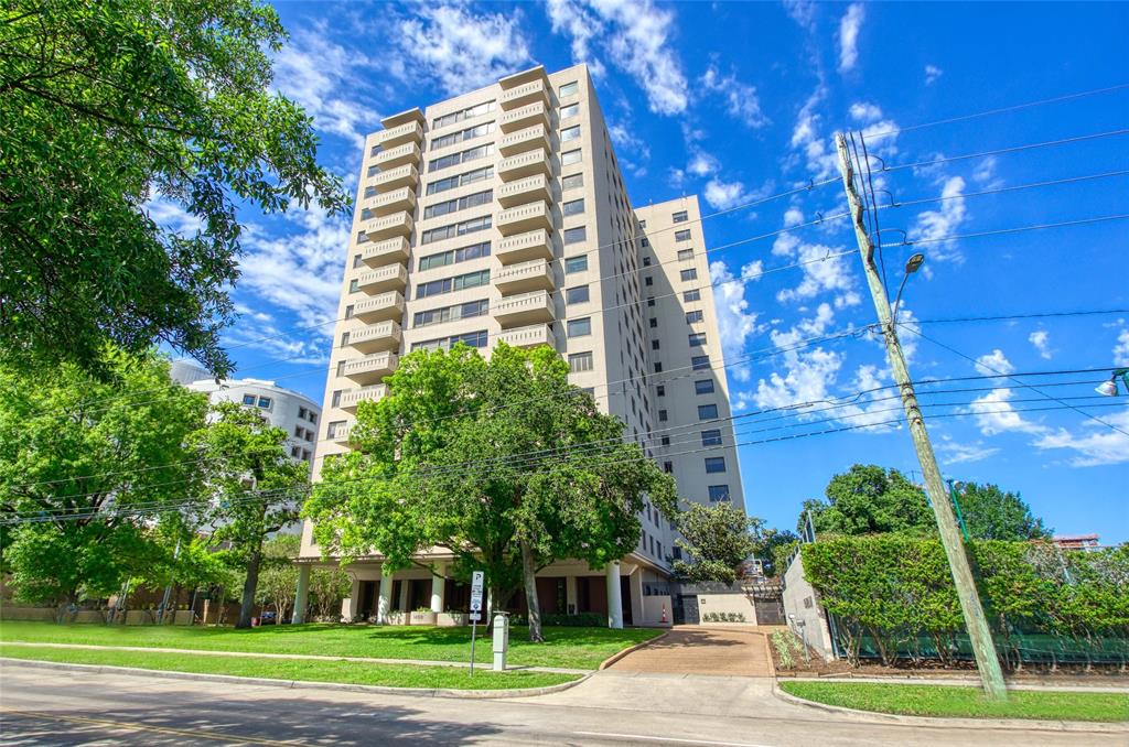 a front view of a multi story building with yard