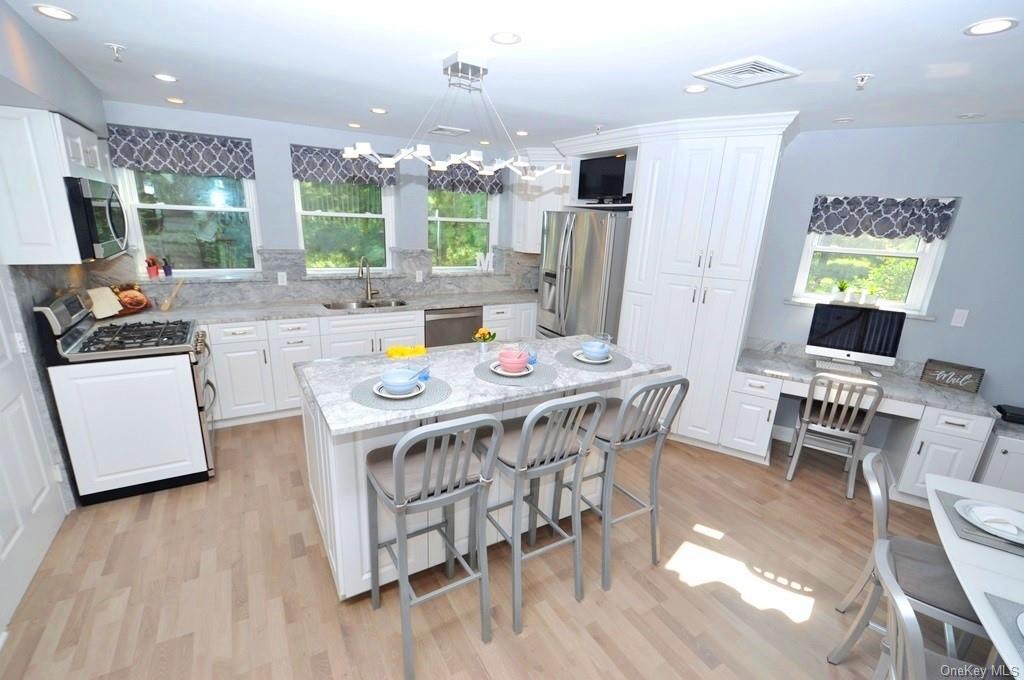 a kitchen that has a table and chairs in it