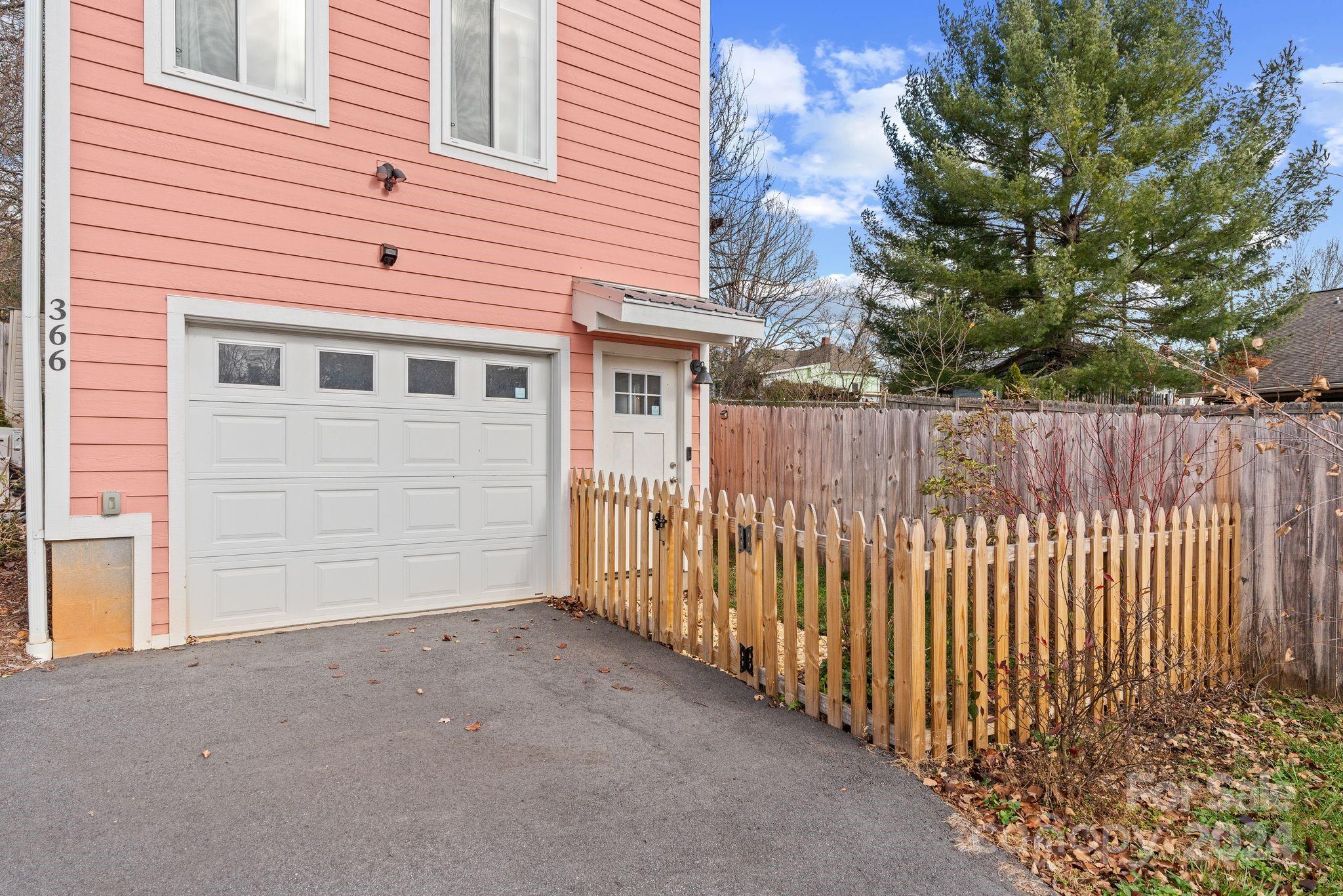 a view of a house with a wooden fence