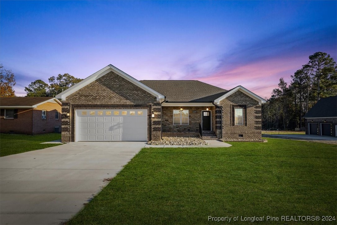 a front view of a house with a yard and garage