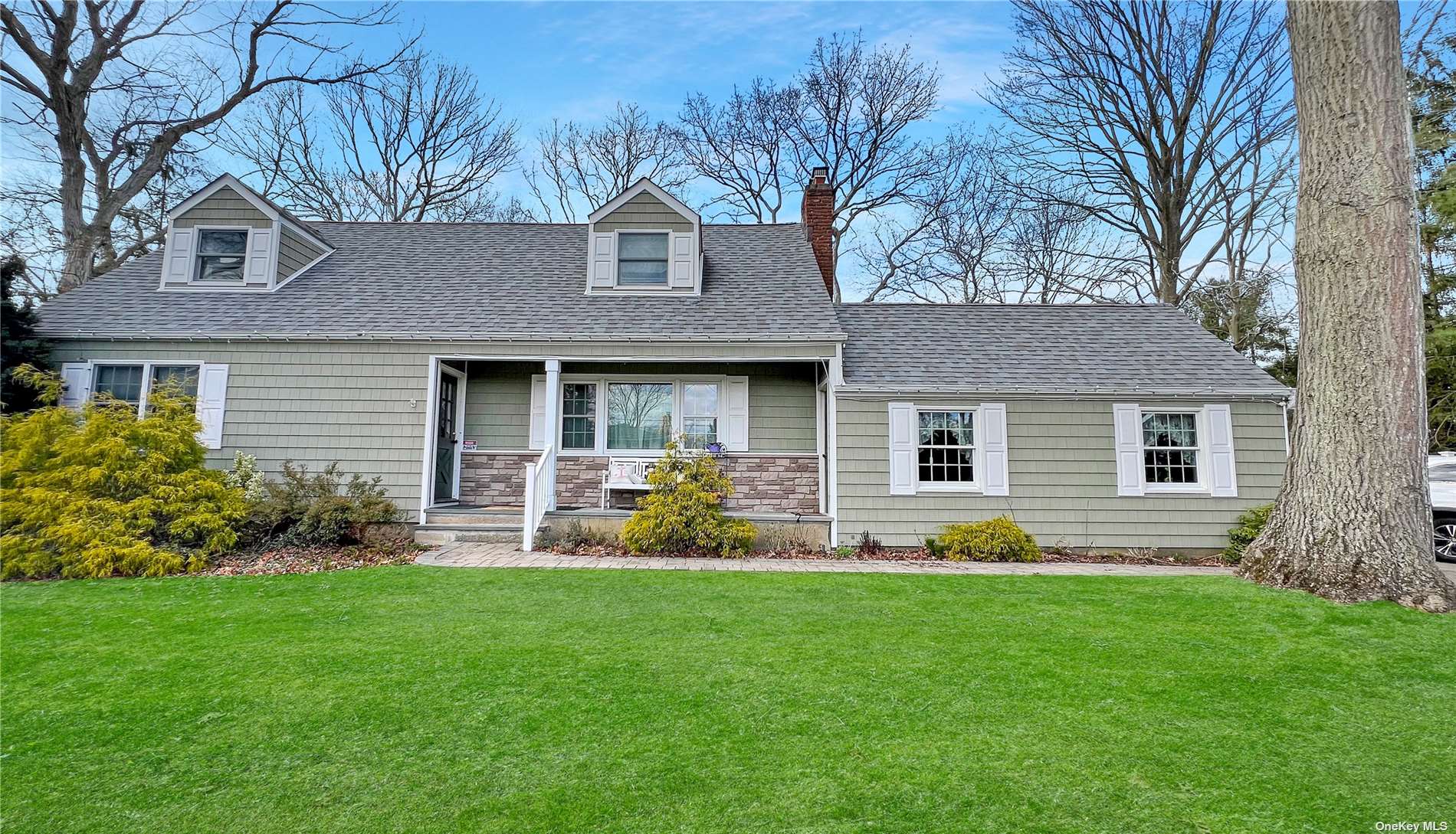 a front view of house with yard and green space