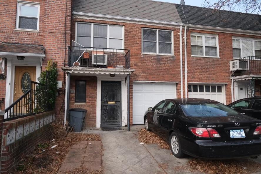 Rear view of house with a garage and a balcony