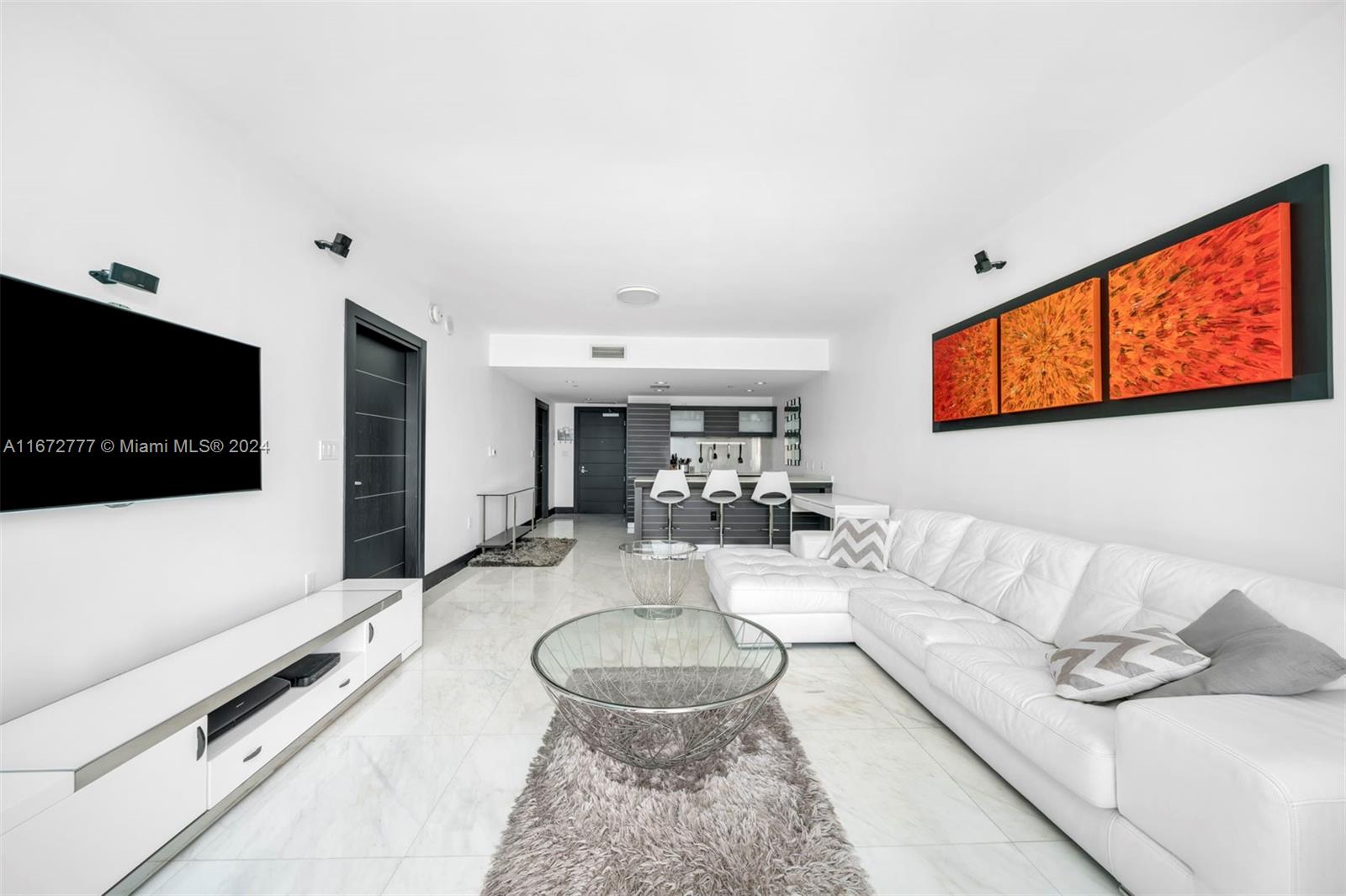 a living room with furniture and a flat screen tv