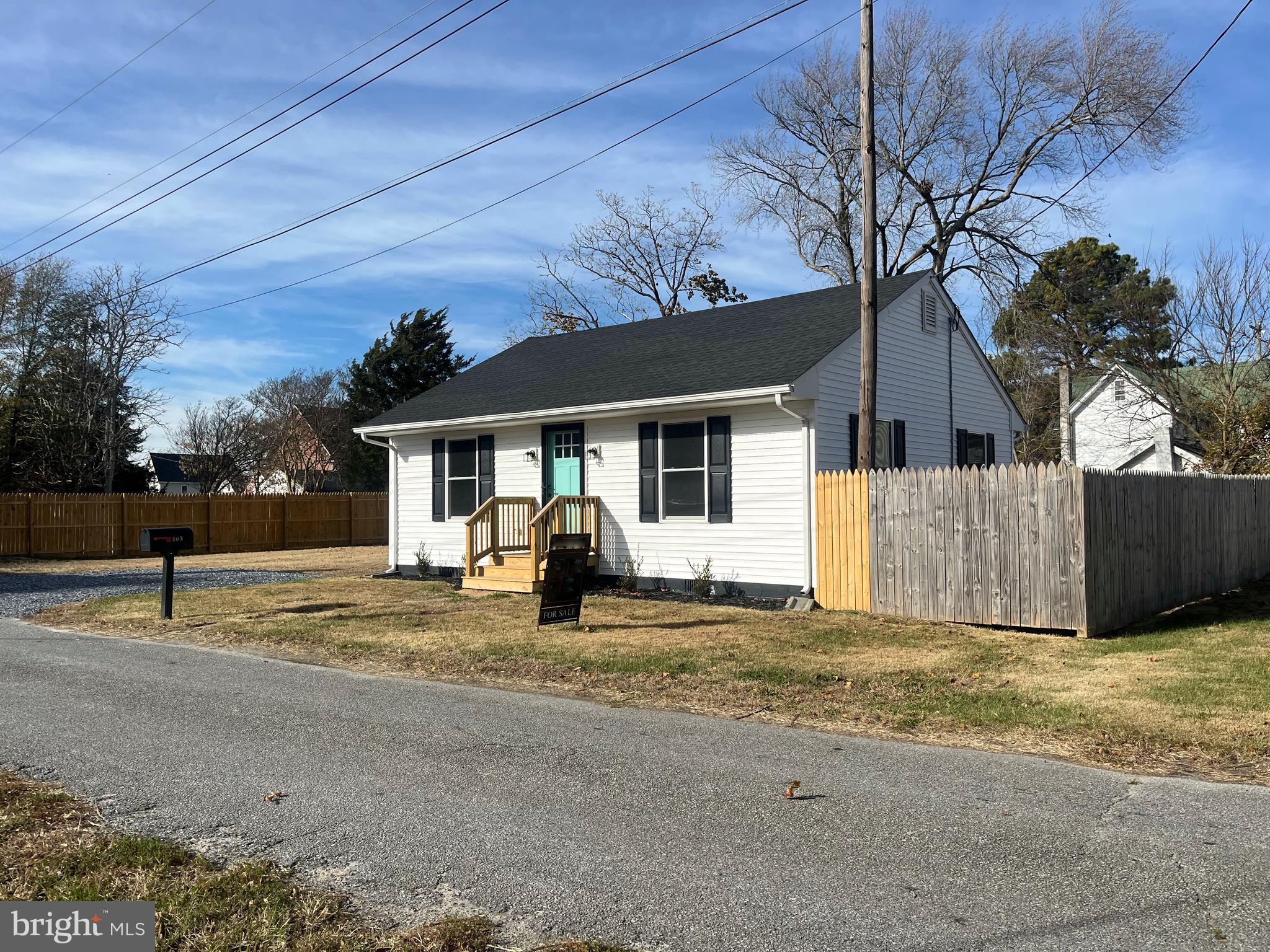 a house that has a tree in front of it