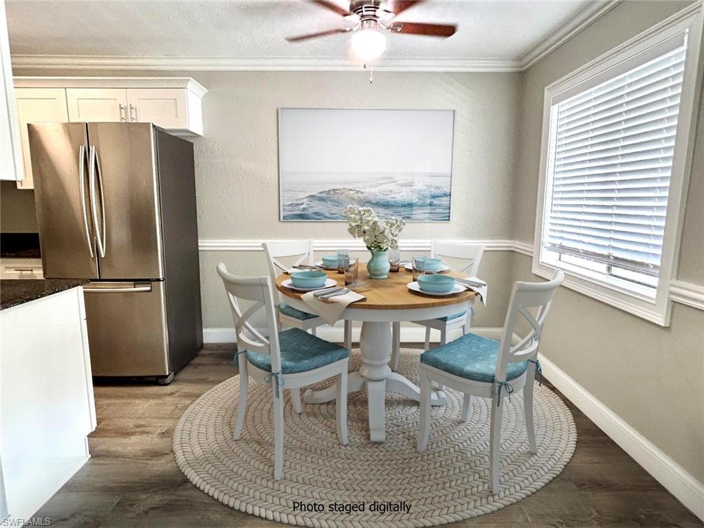 a dining room with furniture a chandelier and wooden floor