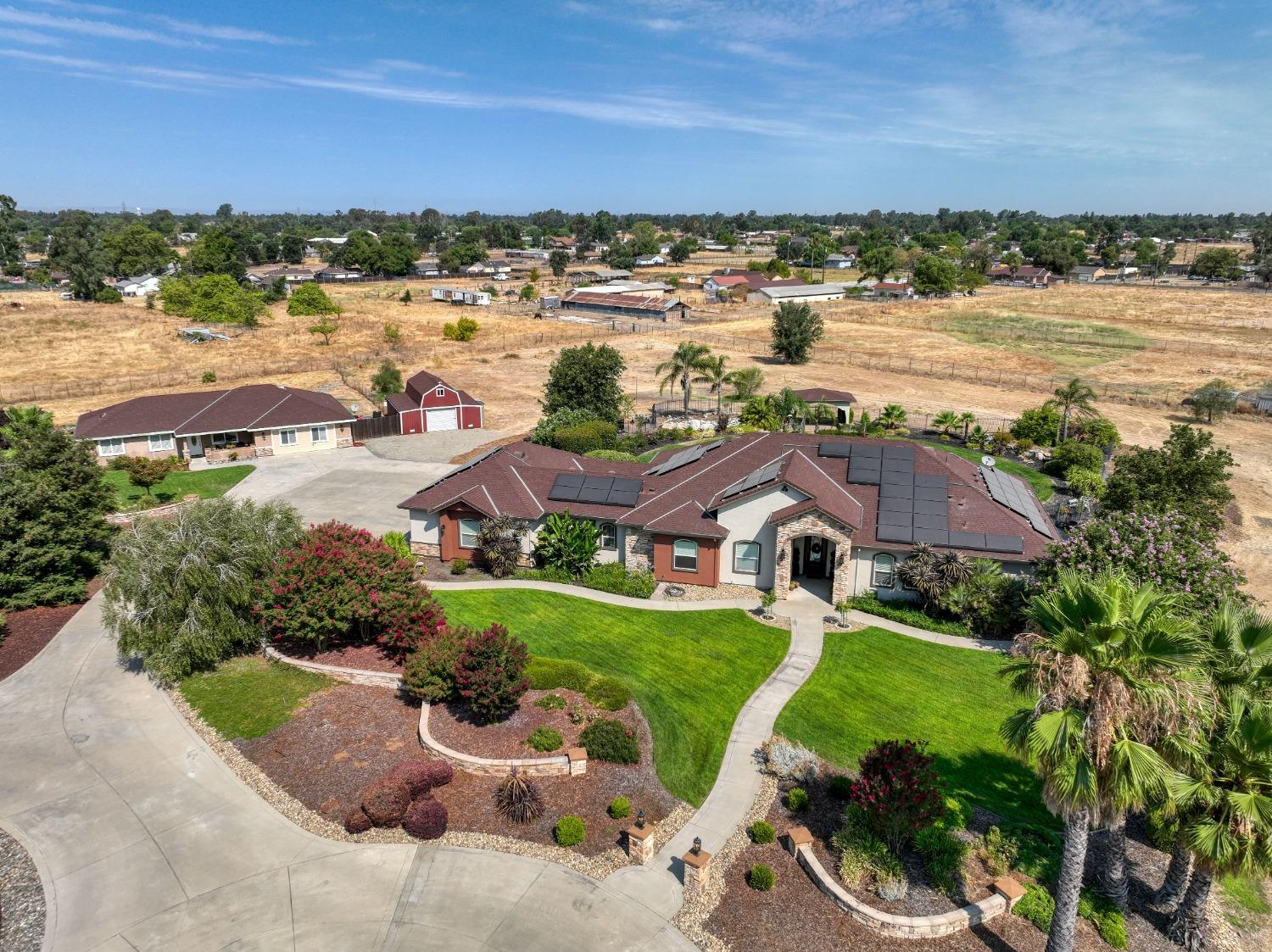 an aerial view of residential houses with outdoor space and lake view