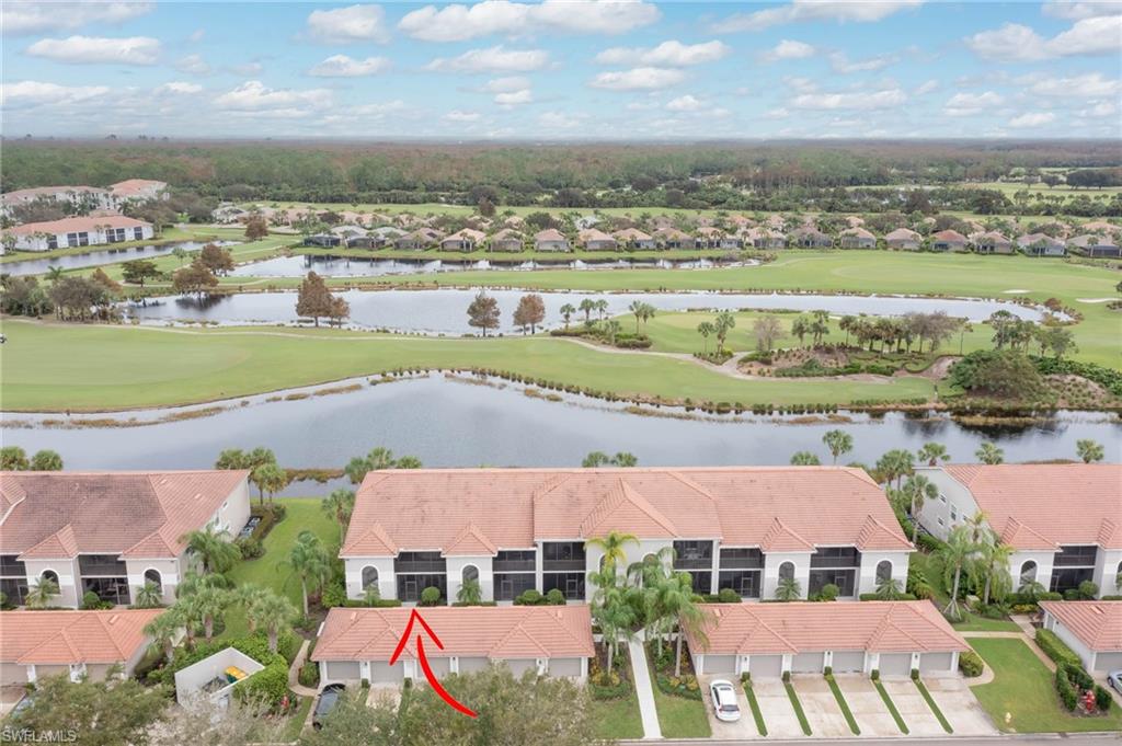 an aerial view of residential houses with outdoor space and river