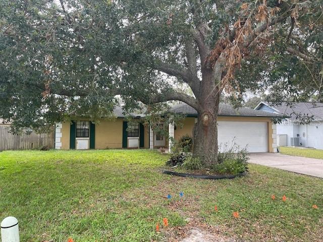 a front view of house with yard and trees