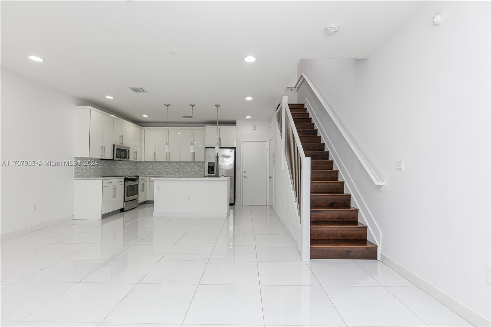 a view of kitchen with wooden floor and electronic appliances