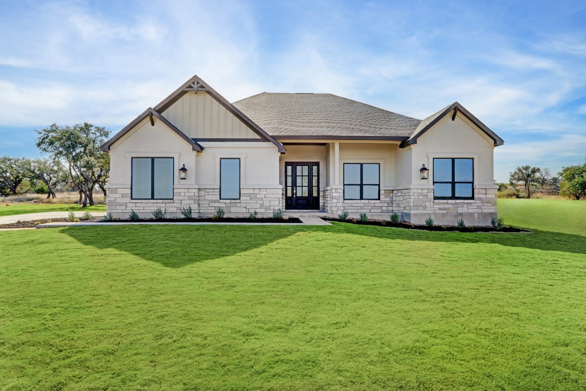 a front view of house with yard and green space