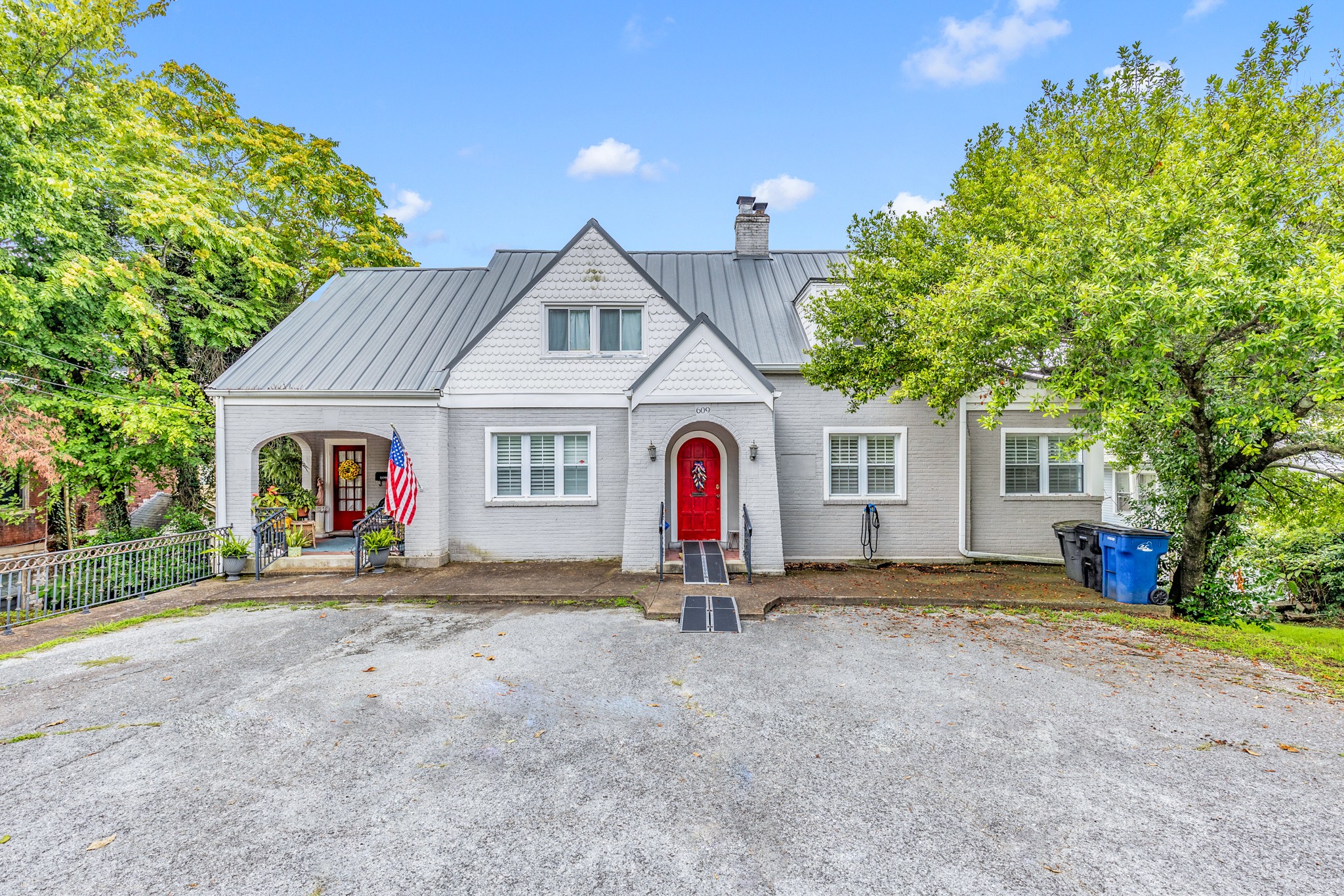 a view of a house with a backyard and a tree