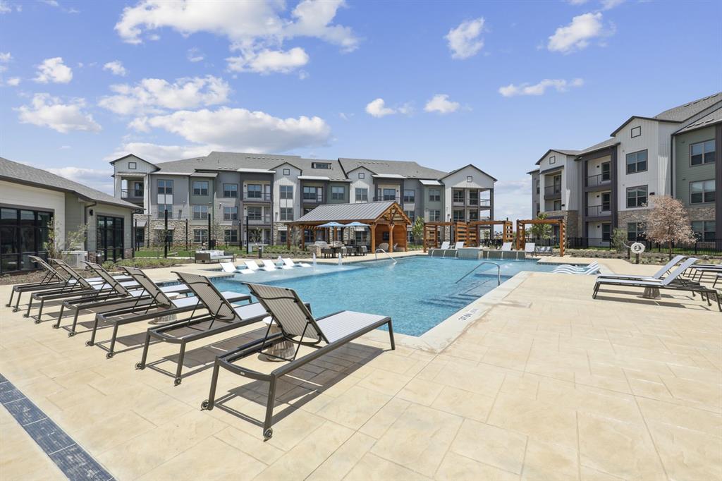 a swimming pool with outdoor seating and yard