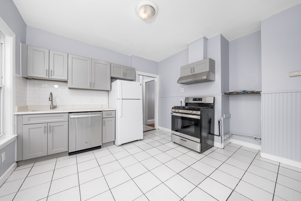 a kitchen with a white cabinets and white appliances