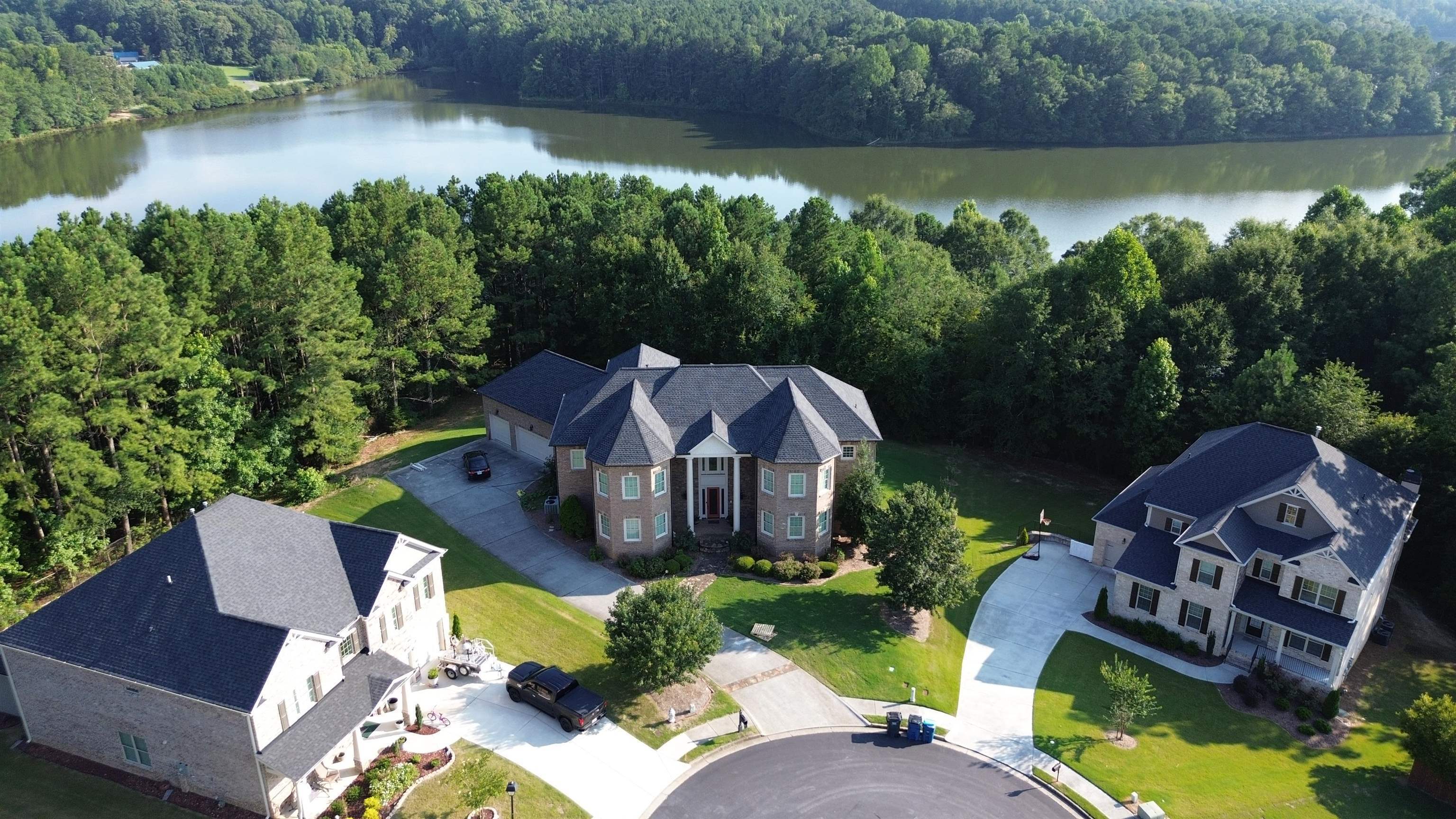 an aerial view of a house with garden space and lake view