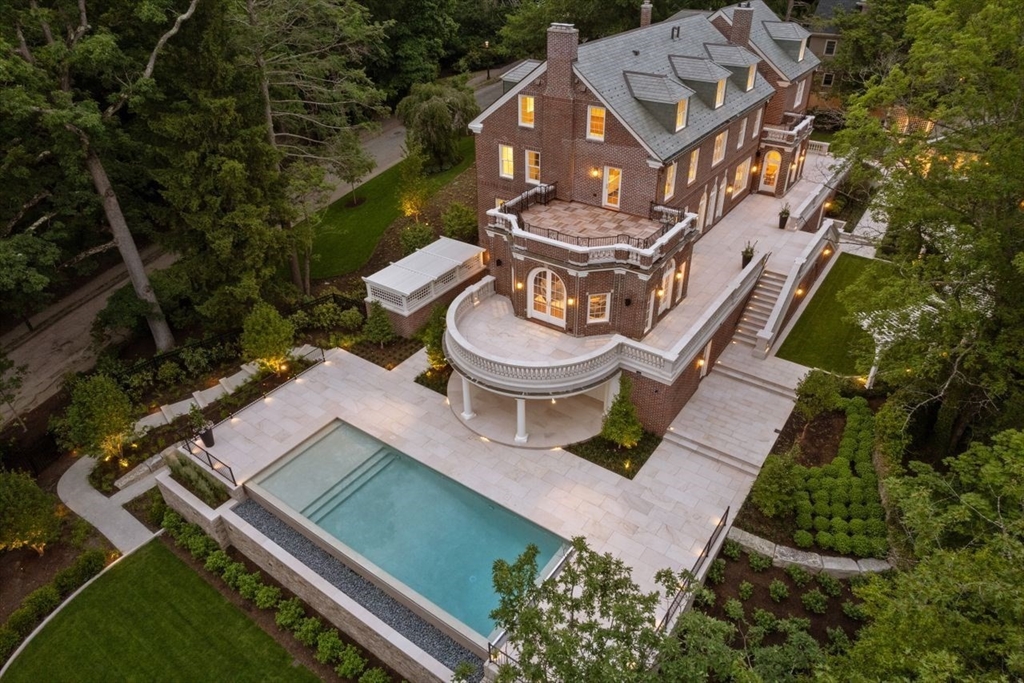 an aerial view of a house with garden space and a lake view