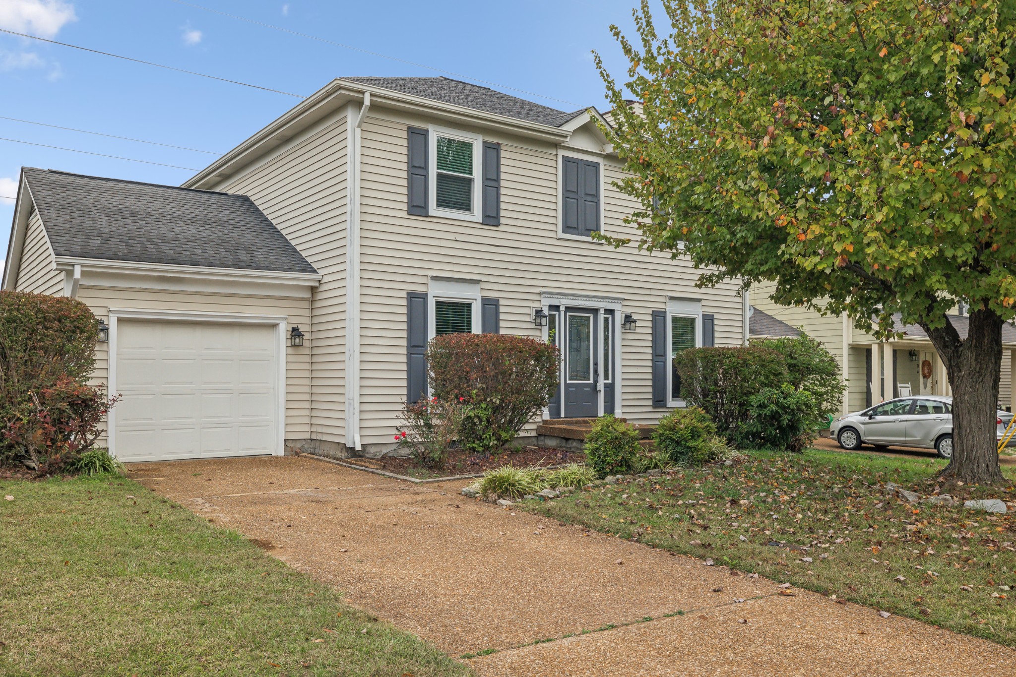 a front view of house with yard and trees around