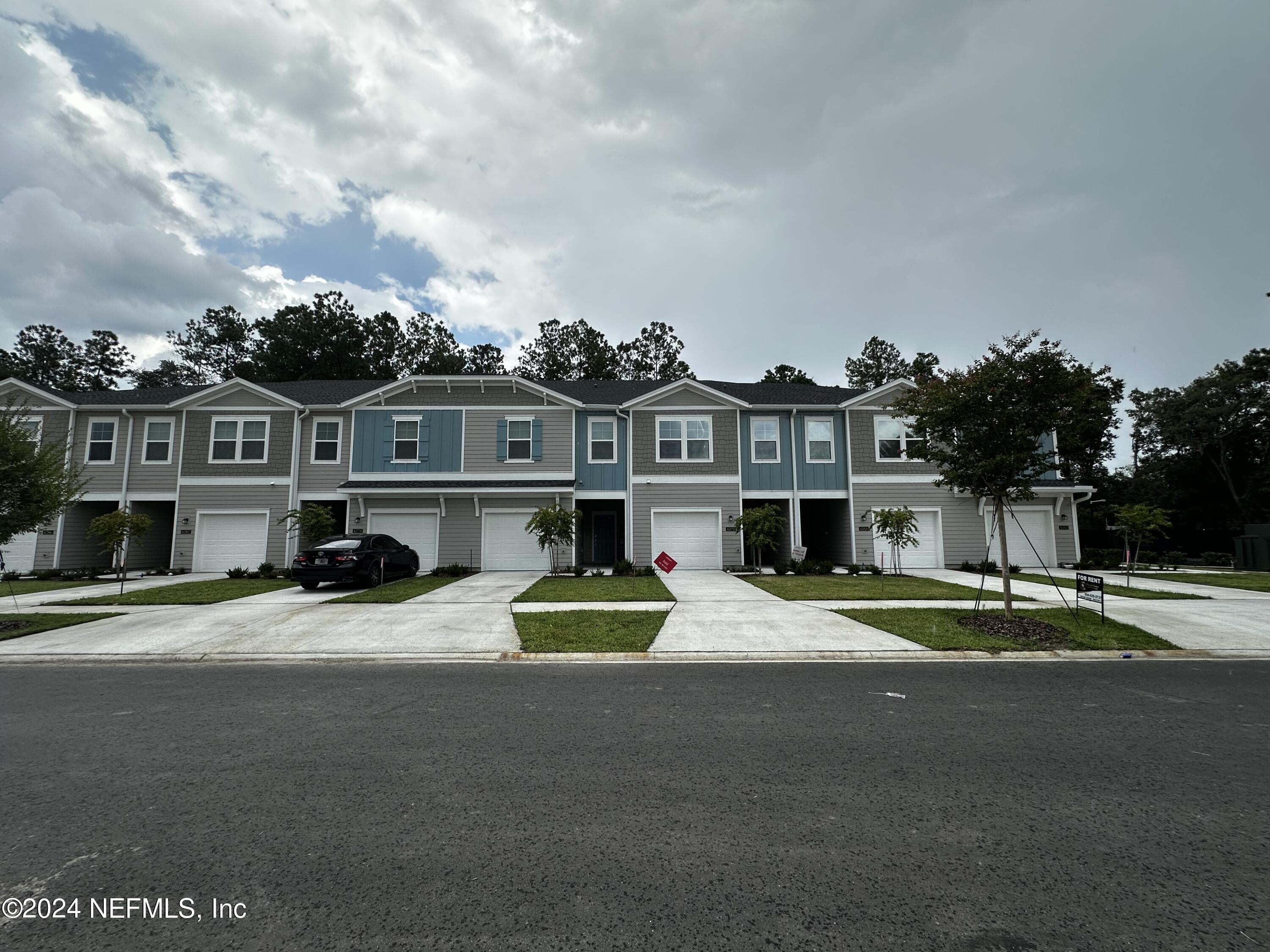 a view of multiple houses with a street