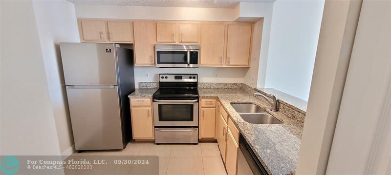 a kitchen with a refrigerator stove and microwave