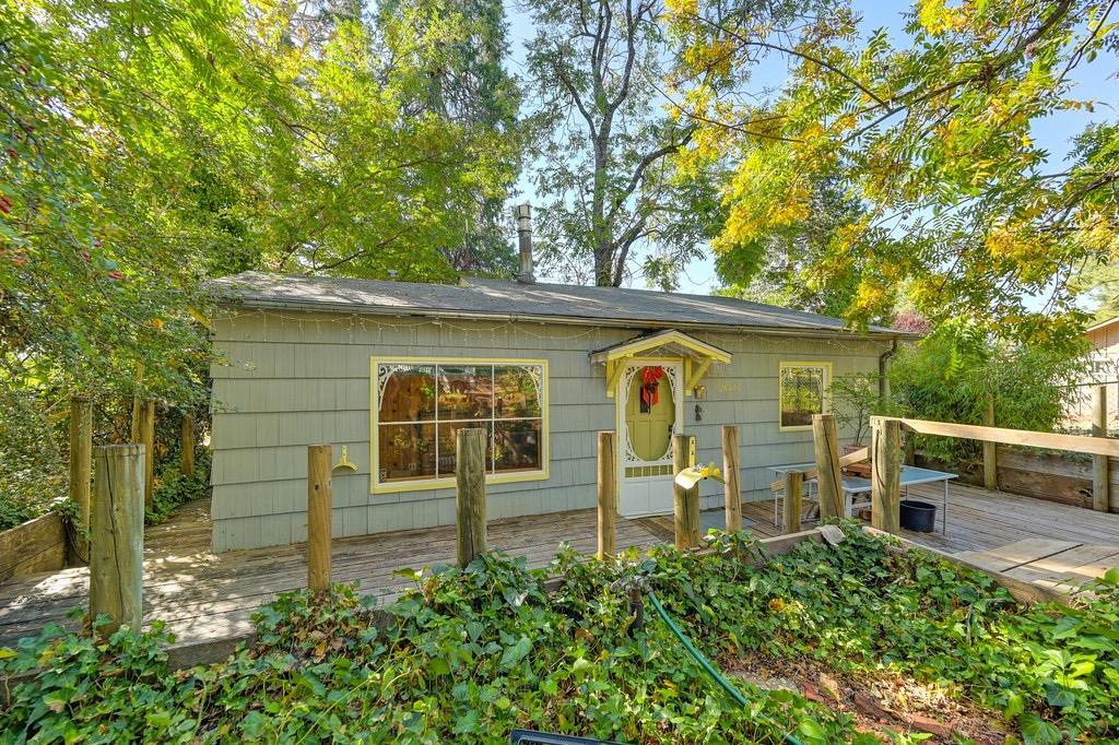 a view of a back yard with a wooden fence