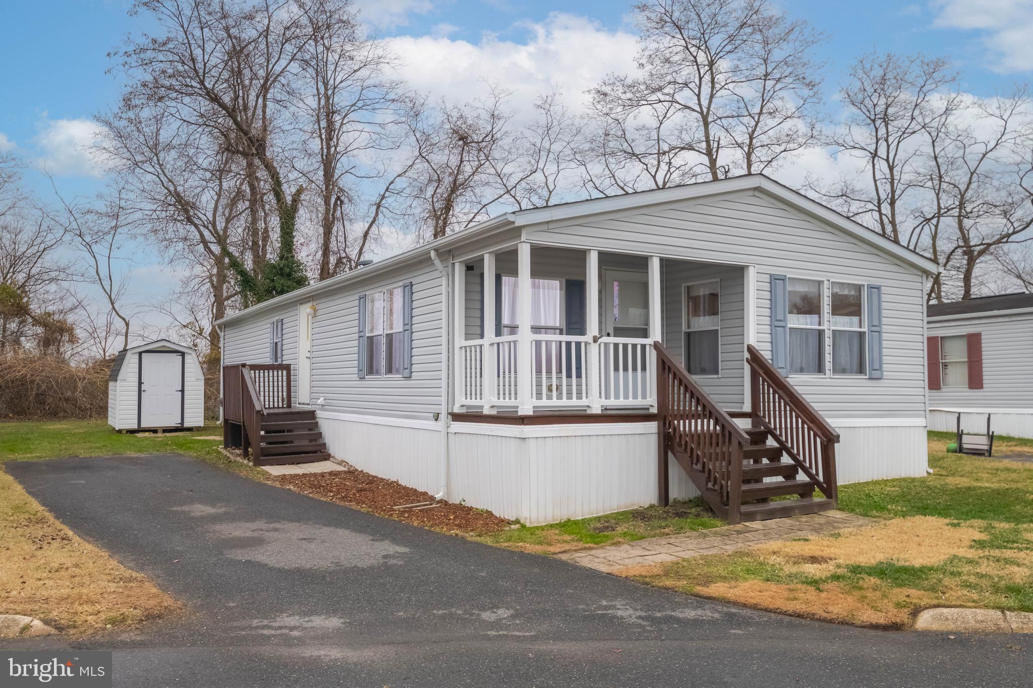 a view of a house with a yard in the background