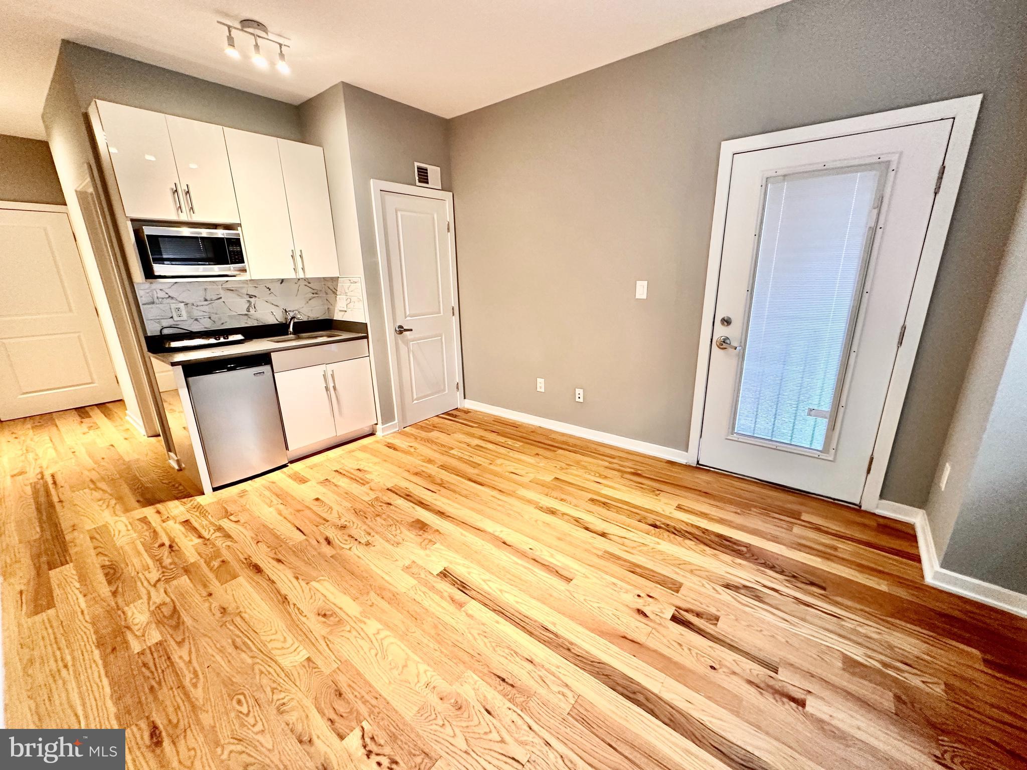 a kitchen with a refrigerator stove and sink