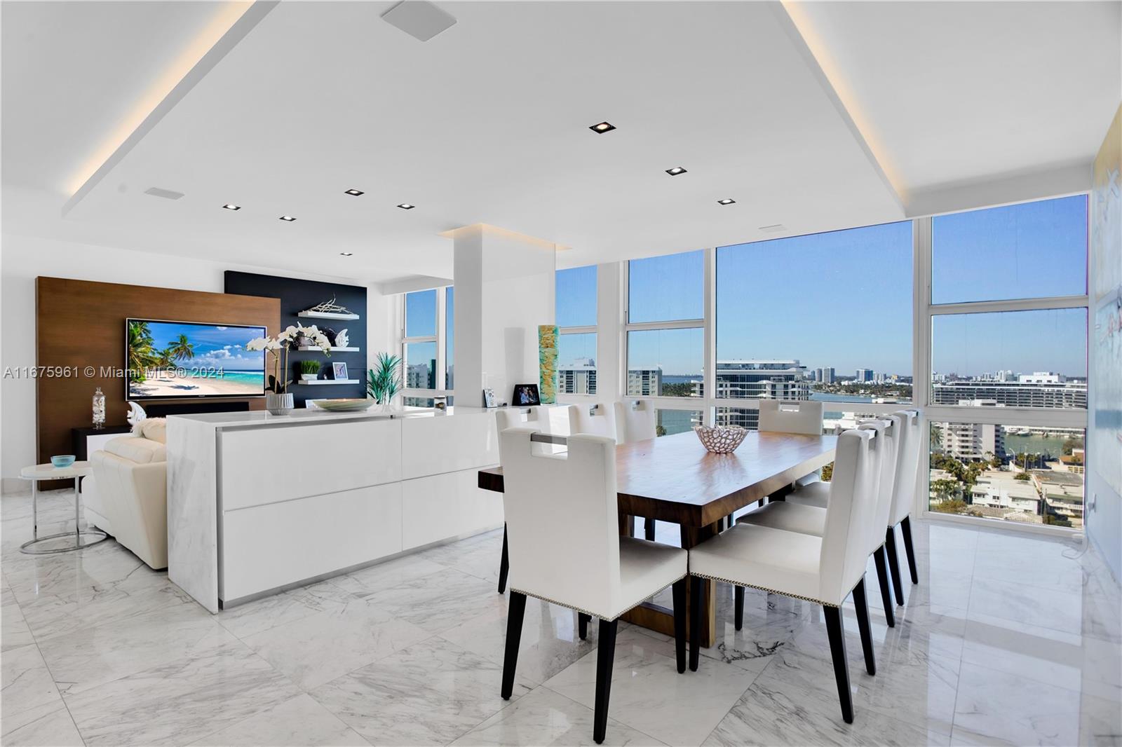 a kitchen with stainless steel appliances kitchen island granite countertop a table and chairs