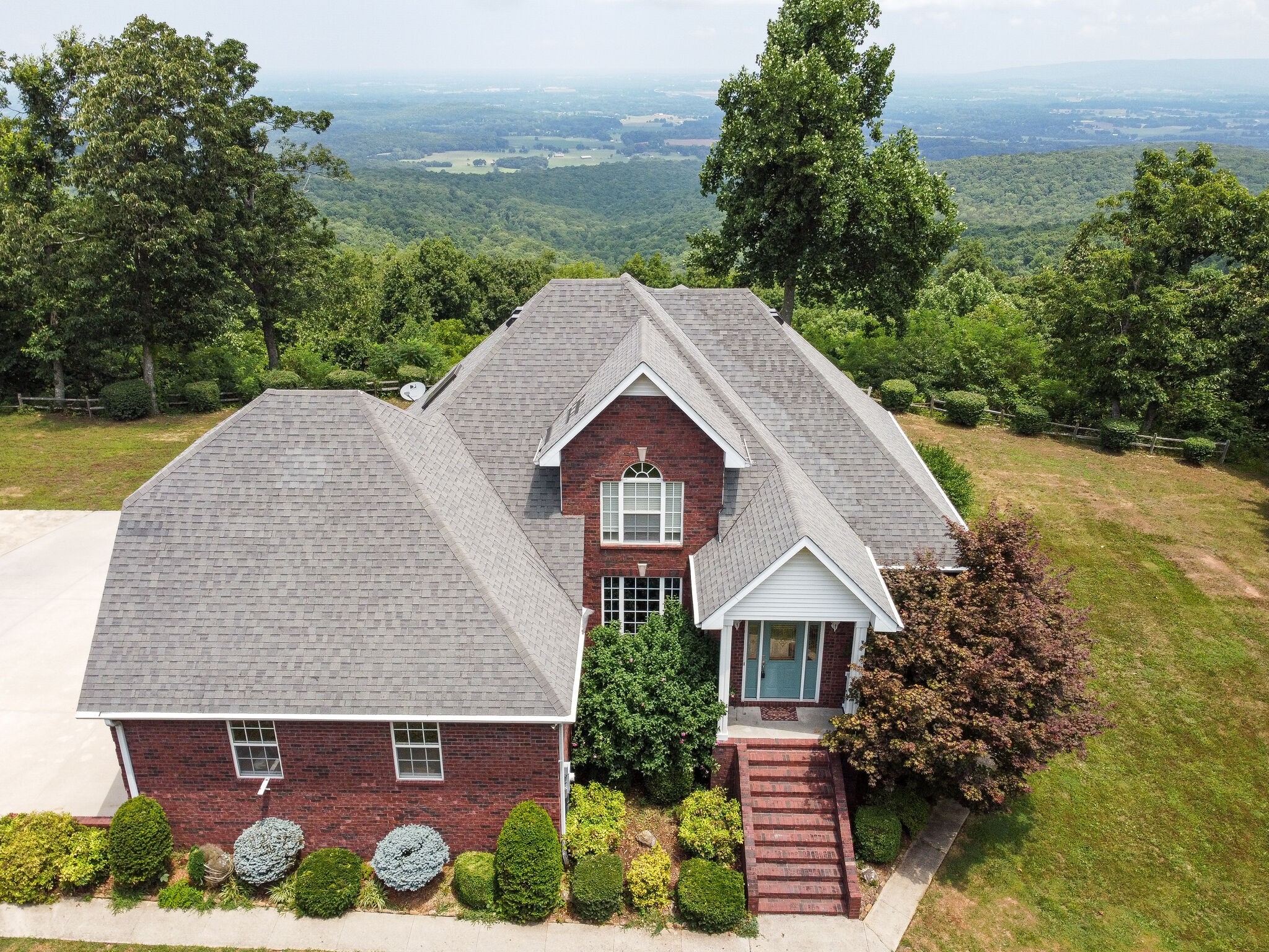 a aerial view of a house next to a yard