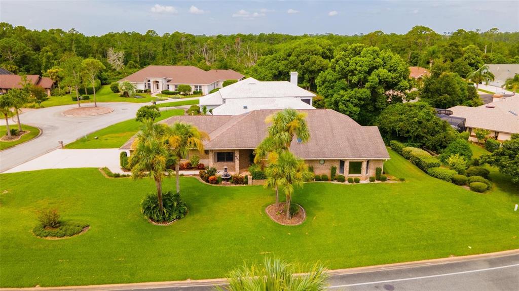 an aerial view of a house with yard swimming pool and outdoor seating