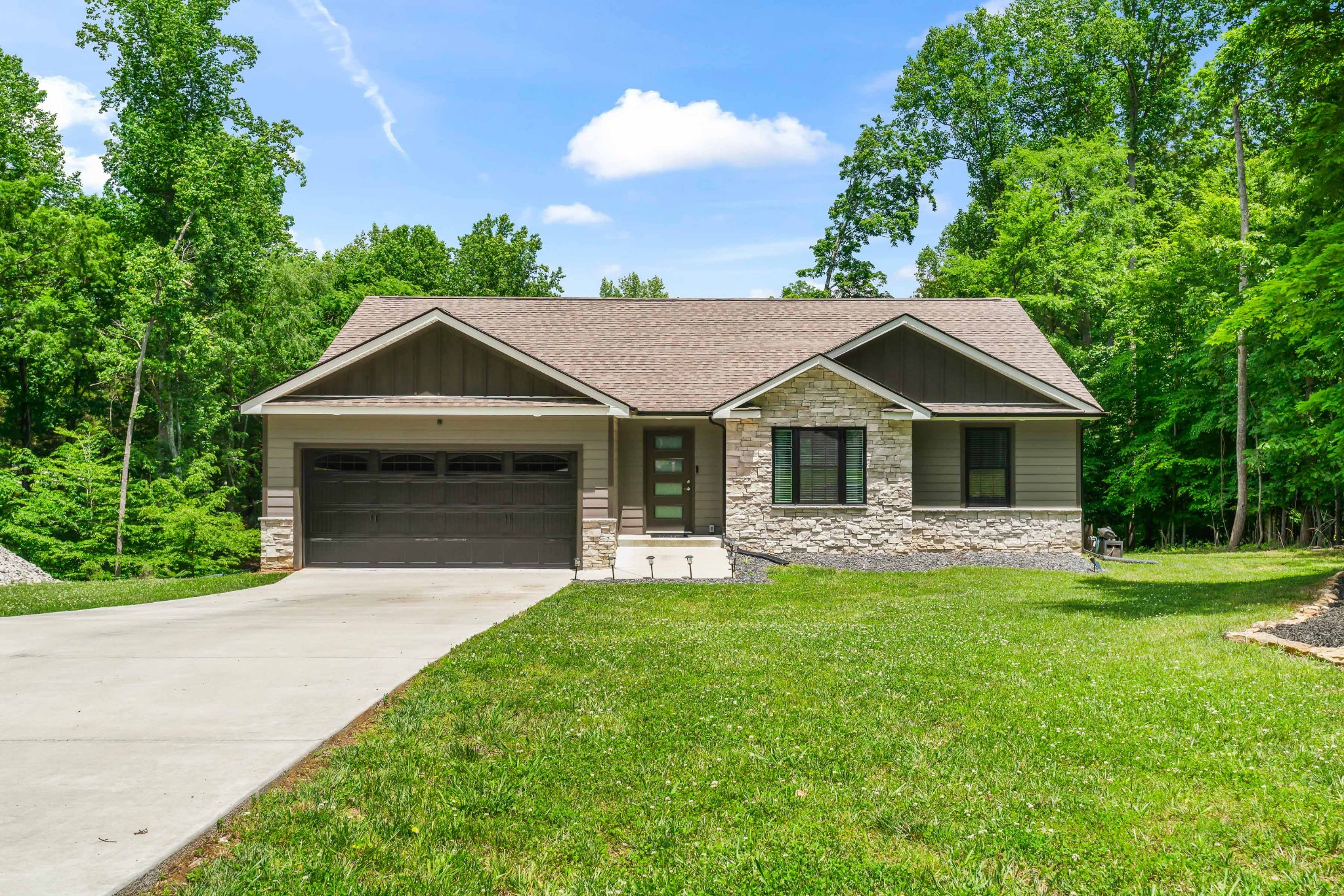 a front view of a house with a garden