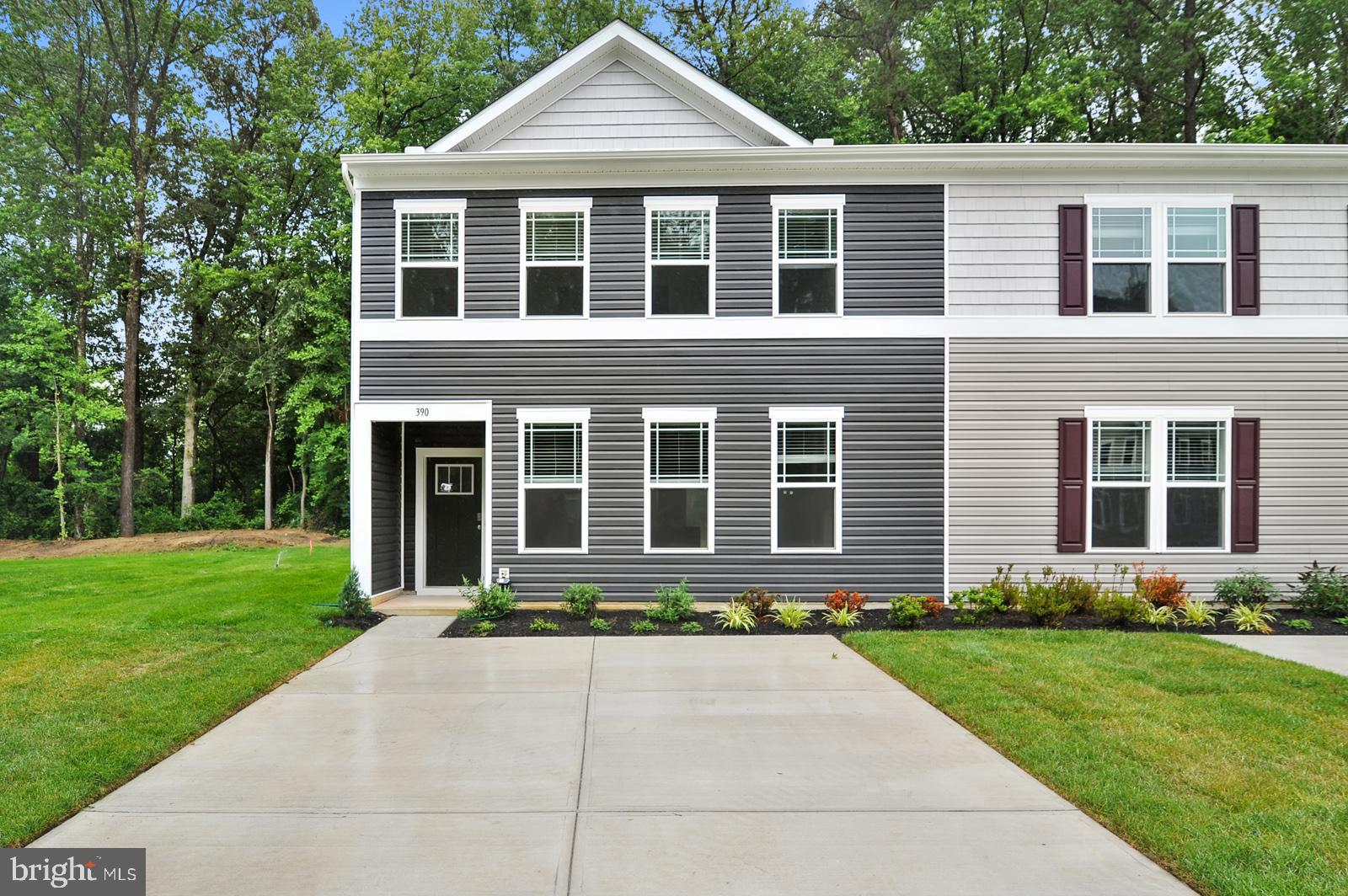 a front view of a house with a yard and outdoor seating