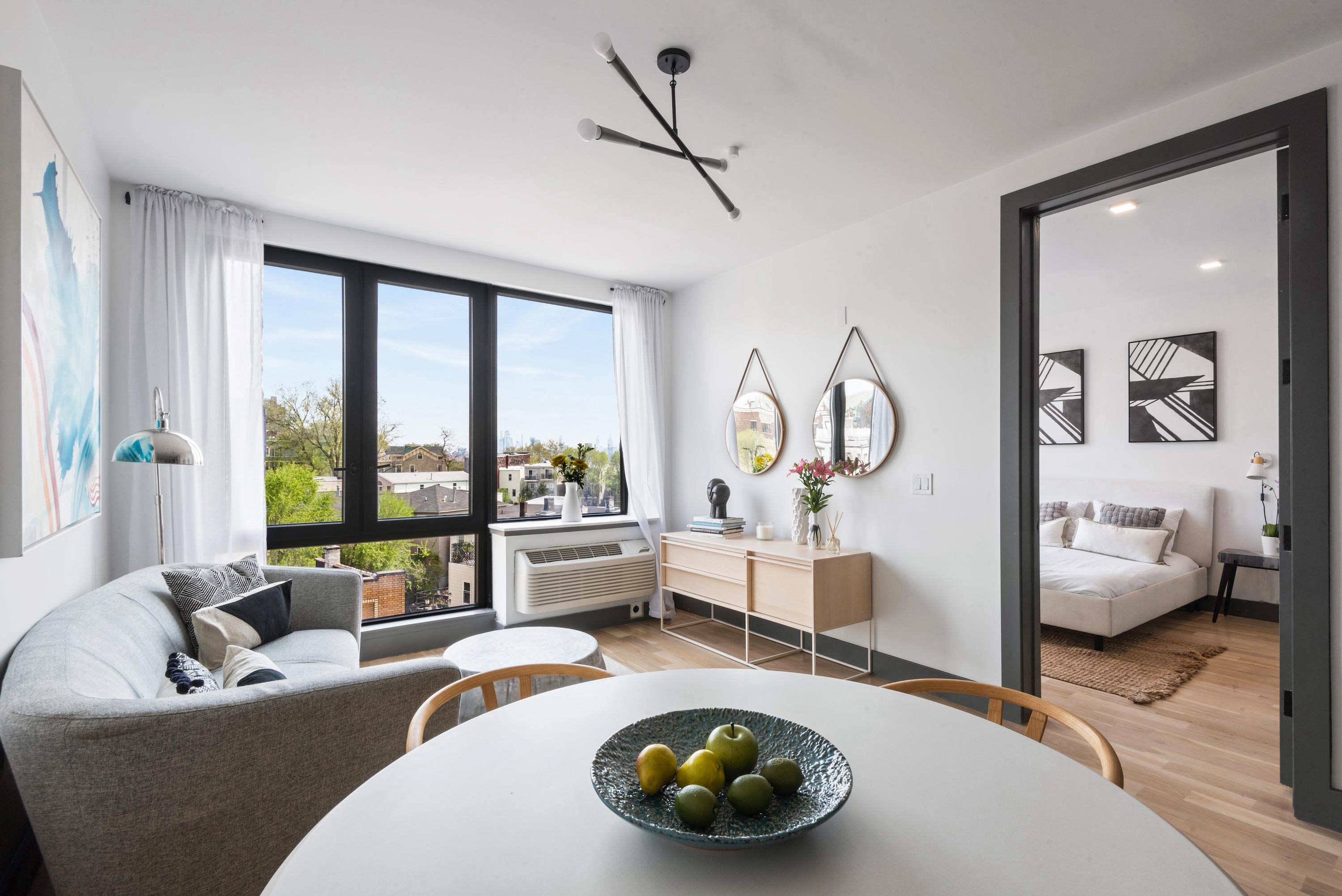 a living room with furniture and a large window