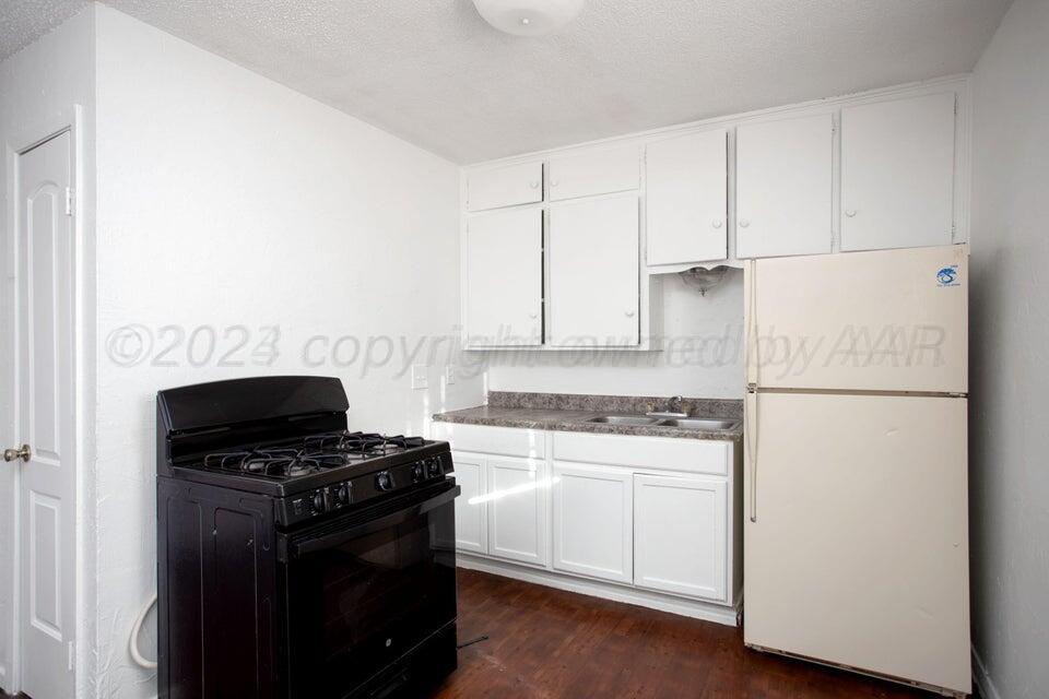 a kitchen with a stove and a refrigerator