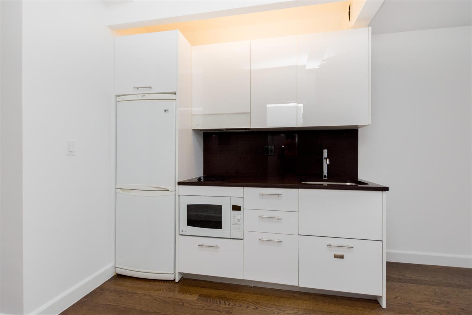 a kitchen with stainless steel appliances a white stove top oven and sink