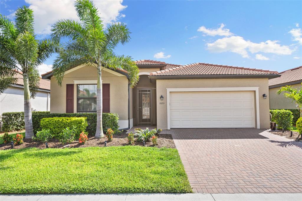 a front view of a house with a yard and garage