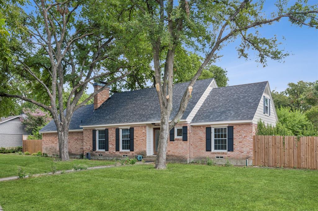 a front view of house with a garden