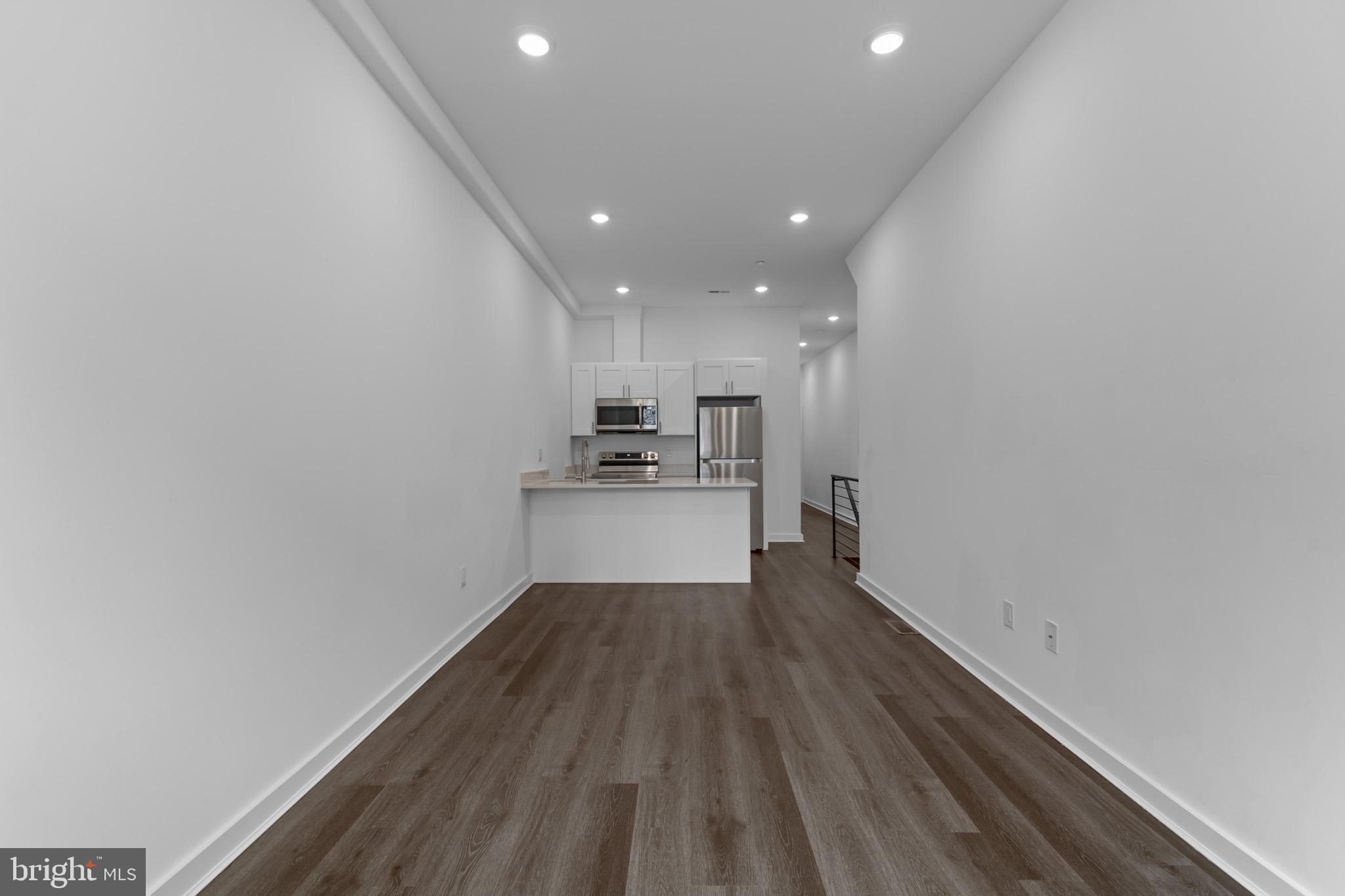 a view of a kitchen with wooden floor